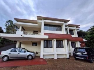 A Beautiful Kerala Home with Western Ghats Views – 67 Cents in Kanjirapally, Kottayam